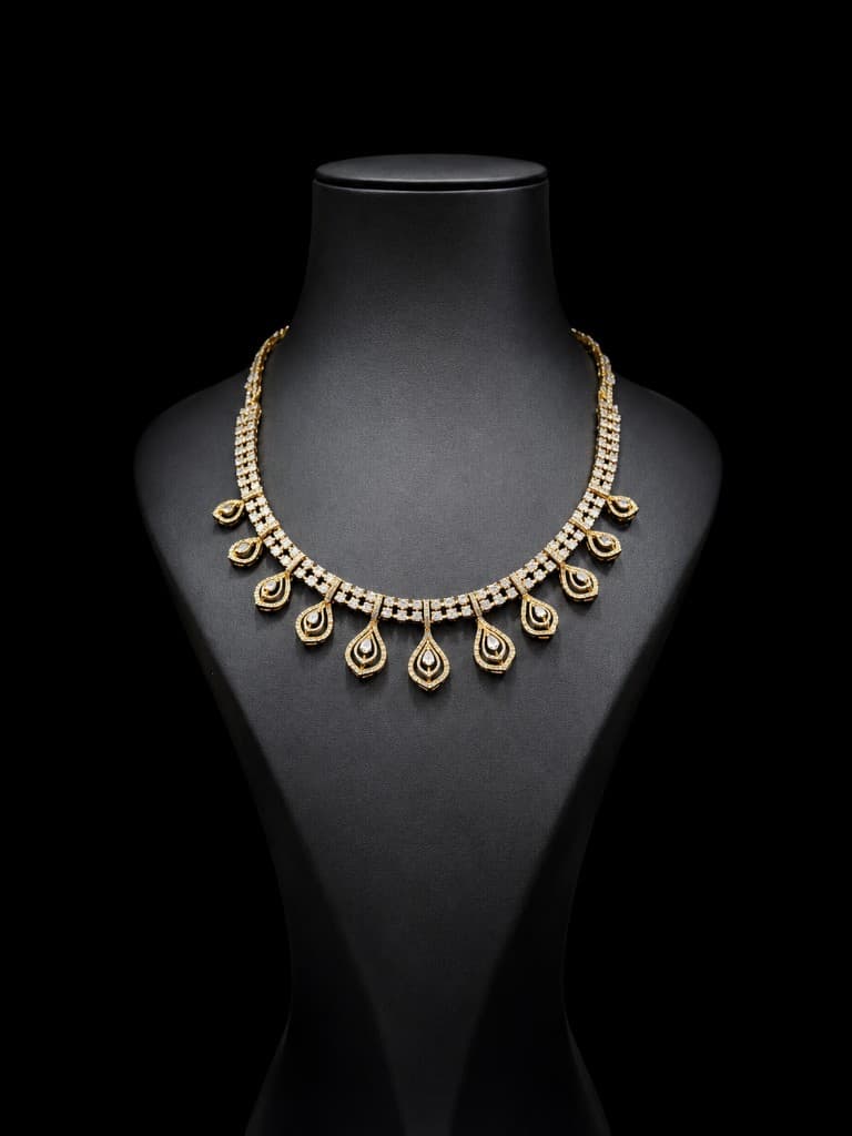 Diamond necklace set with drop motifs on black display bust