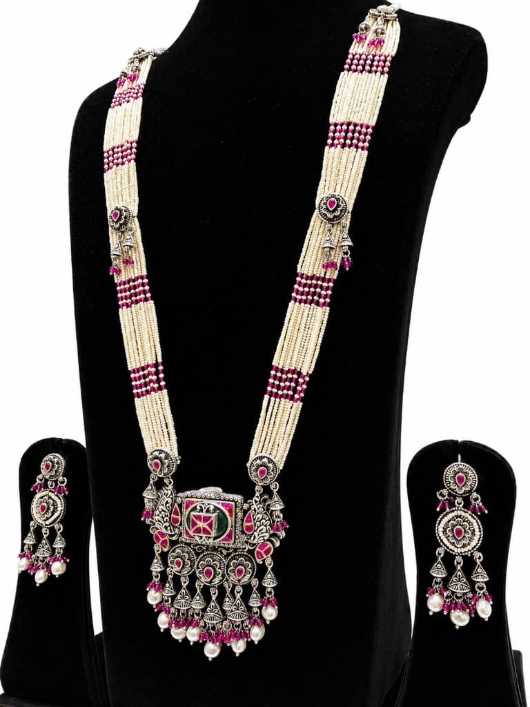 Rajwada oxidised silver necklace and earring set with pearl strands and magenta stone accents